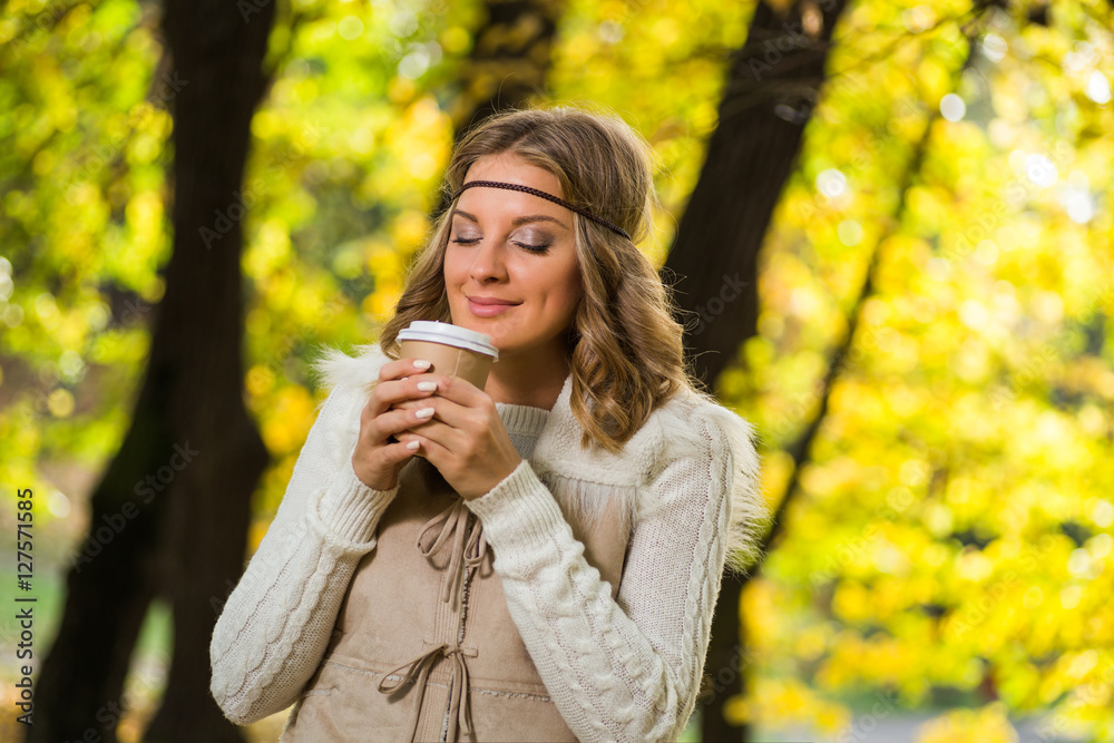 Beautiful boho girl enjoys drinking coffee in the park. Beautiful boho girl enjoys drinking coffee in the park.