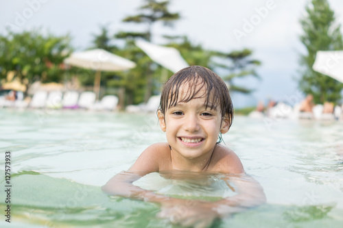 Young boy kid child splashing in swimming pool having fun leisur © Jasmin Merdan