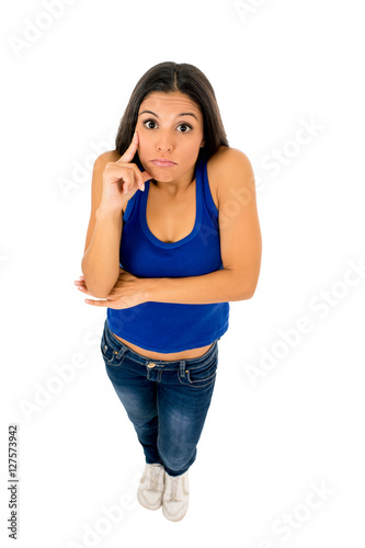 hispanic woman shrinking shoulders pointing her head thinking and wondering