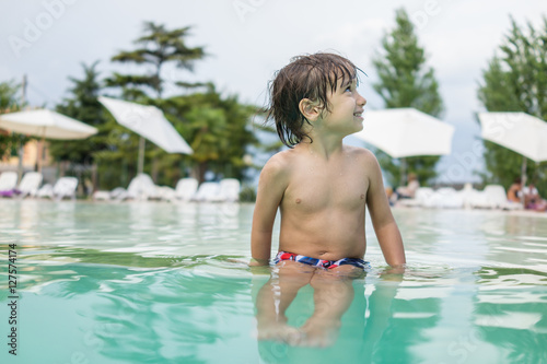 Young boy kid child splashing in swimming pool having fun leisur © Jasmin Merdan