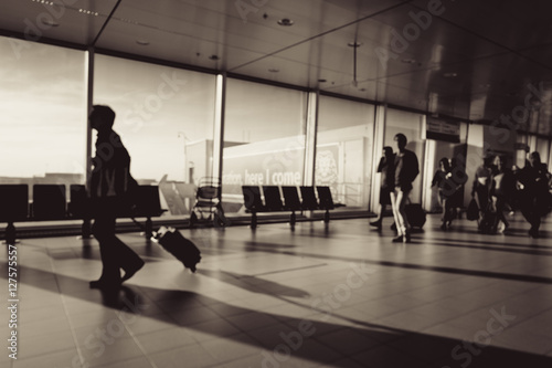 Blur of  Siluate people visit departure hall in airport.