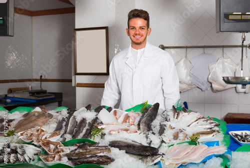 Young salesman offering fresh fish