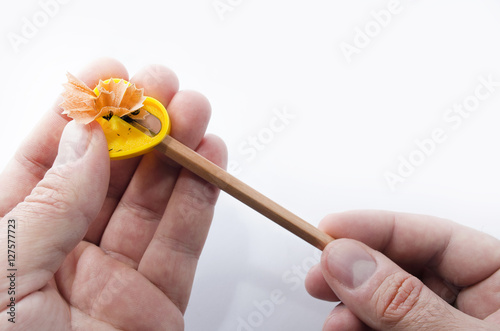 Pencil sharpener and hands isolated photo