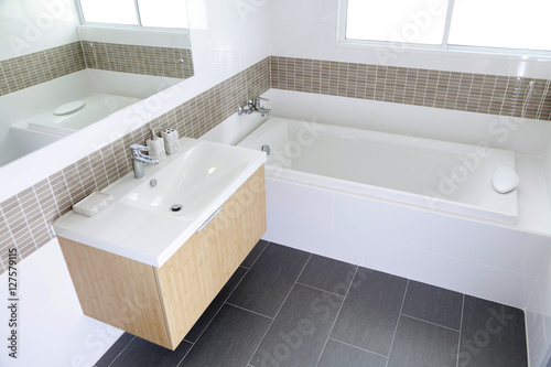 White sink and dispenser in bathroom photo