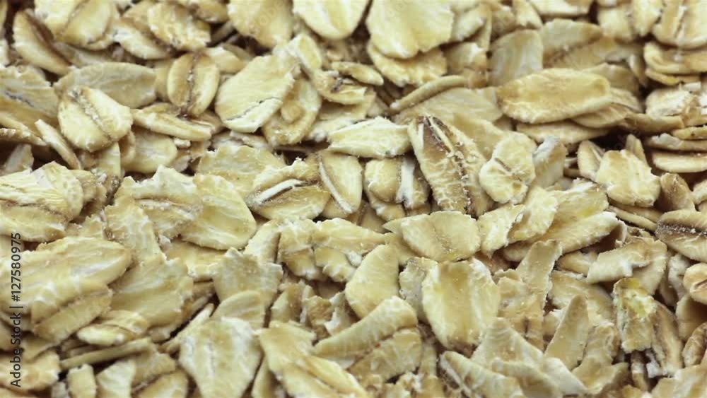 Rotating rolled oats flakes closeup Rotating rolled oats flakes closeup