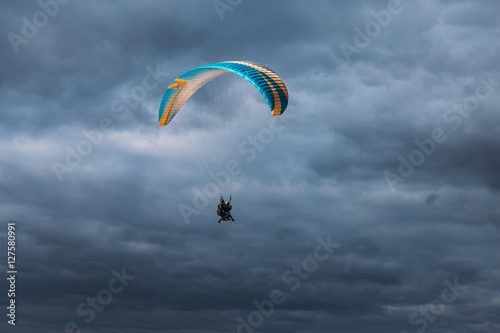 Paraglider in the blue dark sky