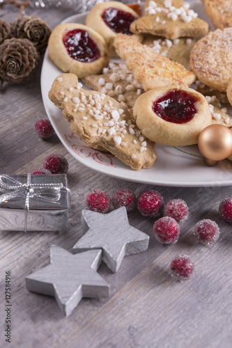 christmas cookies with stars and present on wooden background