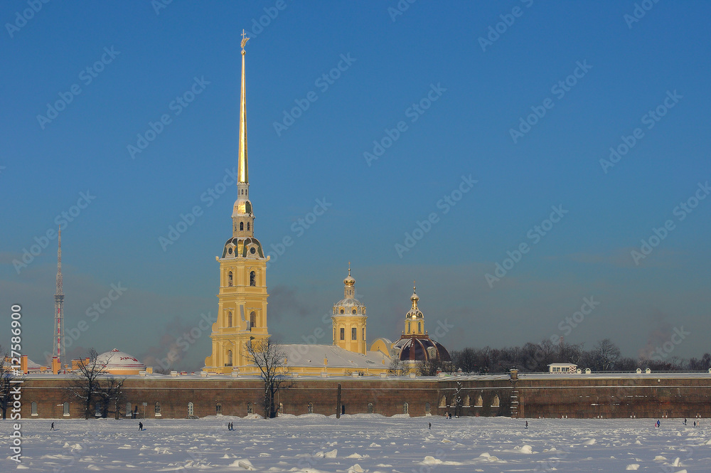 Very cold winter sunny day in the city center of St. Petersburg. View of Peter and Paul Fotrress from the frozen Neva river.