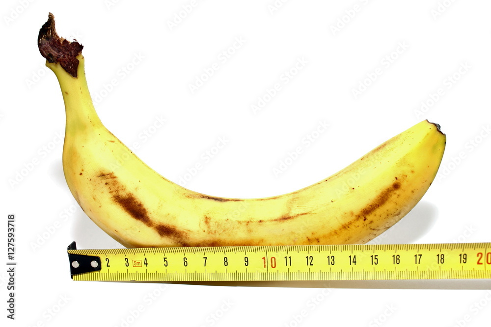 Large banana and measuring tape Isolated on white background, such as man's large  penis, big size. Concept of a man's penis size. Comparable to man penis  size as large size. Stock Photo