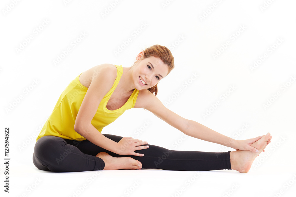 Fit woman stretching her leg to warm up - isolated over white background Fit woman stretching her leg to warm up - isolated over white background