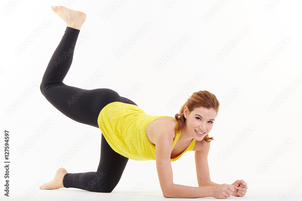 young woman doing stretching in studio background young woman doing stretching in studio background
