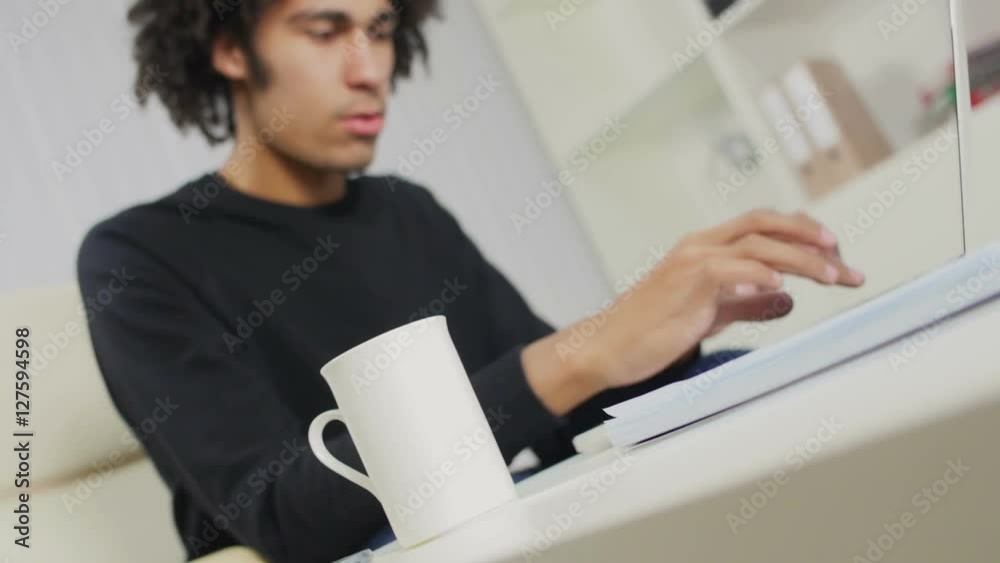 The young black guy does the report on the computer The young black guy does the report on the computer