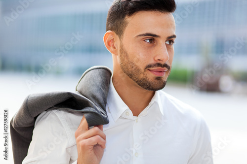 Young businessman holding his jacket outdoor © Minerva Studio