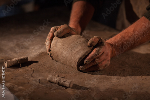 Fototapeta Naklejka Na Ścianę i Meble -  Hands of the potter knead clay.