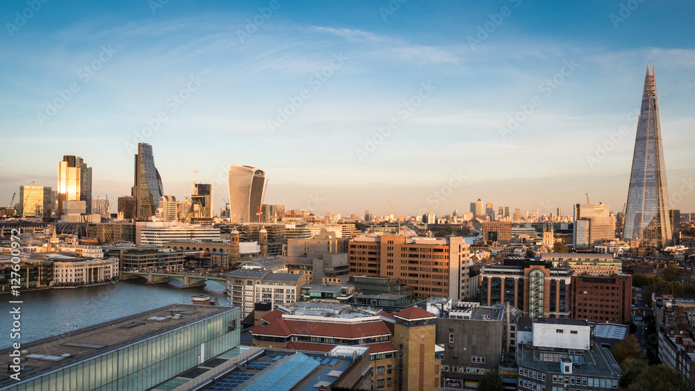London Skyline at dusk. Wide angle panoramic view over the City of London, the River Thames and the iconic Shard skyscraper.