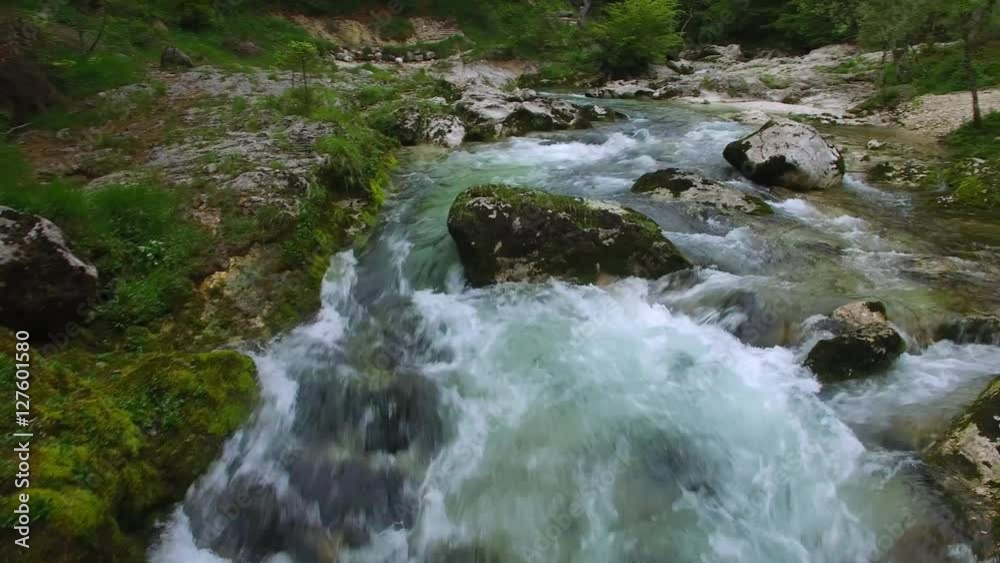 AERIAL: flight over the surface of a mountain river.Mostnica, Slovenia ,camera moving farwards AERIAL: flight over the surface of a mountain river.Mostnica, Slovenia ,camera moving farwards