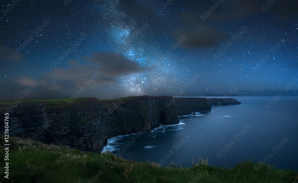 Milky way over dramatic Cliffs of Moher and wild Atlantic Ocean, Ireland