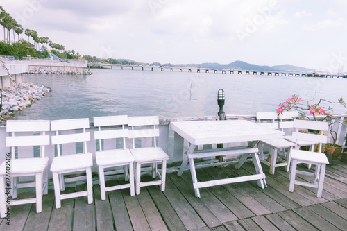Terrace sea view with outdoor wood chairs and table. Vintage color    