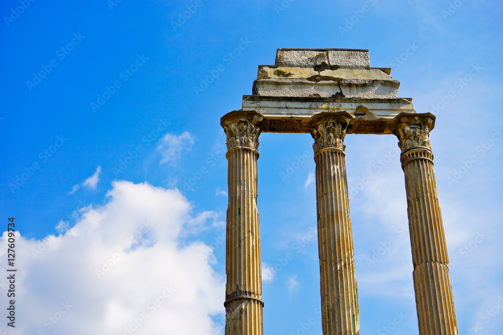 View of the columns of roman ruins in a sunny day in Rome, Italy.