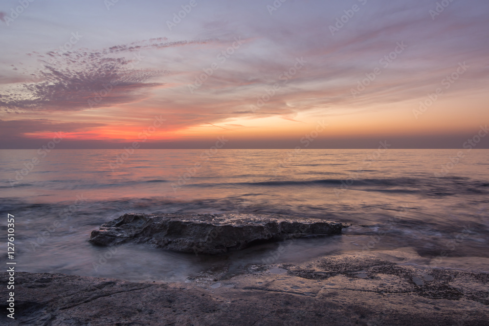 Obraz premium Pastel colors and bright red after sunset at Nahariya Beach