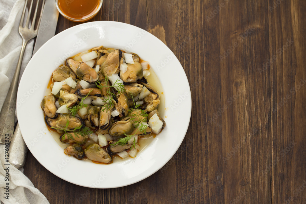 salad mussels with onion in sauce in white plate salad mussels with onion in sauce in white plate