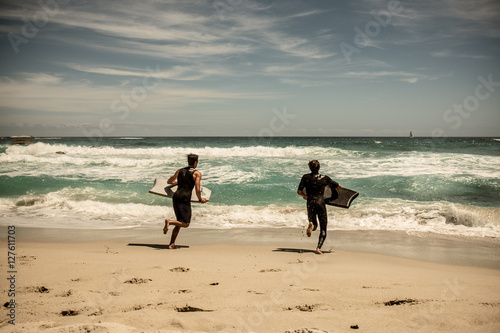 Surfers at clifton beach, cape town.