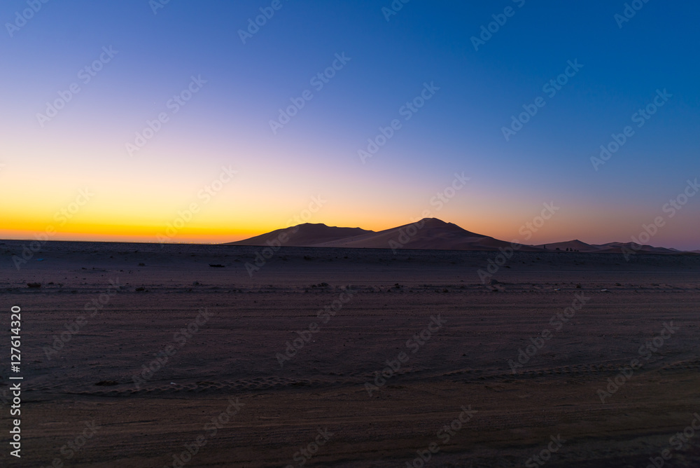 Colorful sunset over the Namib desert, Namibia, Africa. Scenic sand dunes in backlight in the Namib Naukluft National Park, Swakopmund.