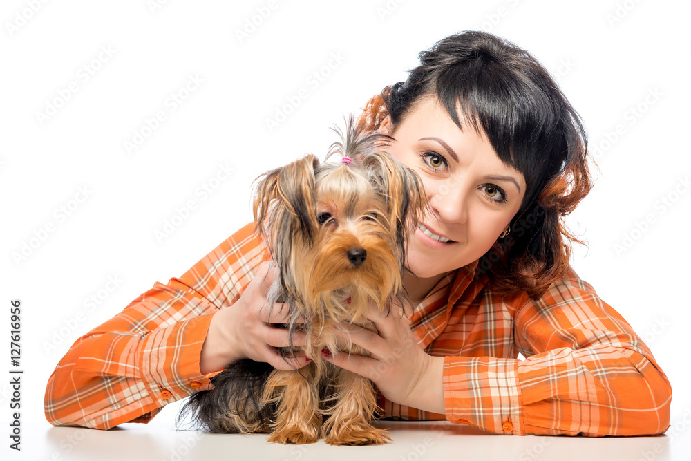 Happy woman posing with her Yorkshire terrier on a white backgro Happy woman posing with her Yorkshire terrier on a white backgro