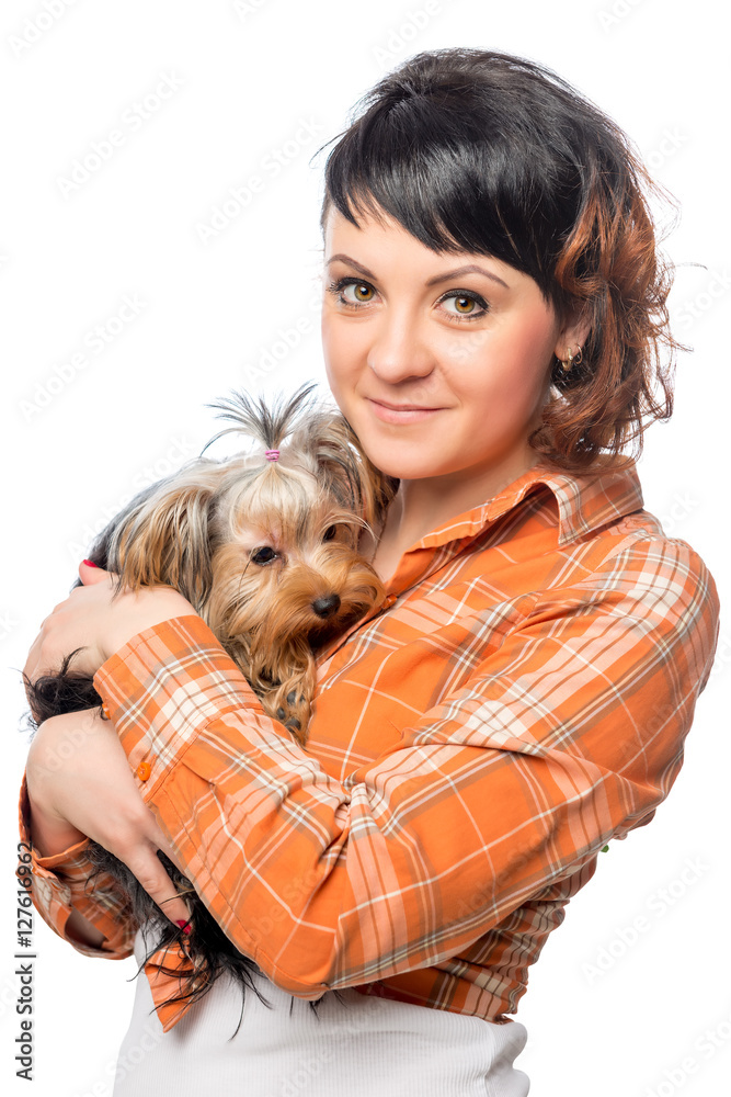 Vertical portrait of a beautiful girl with a small dog on a whit