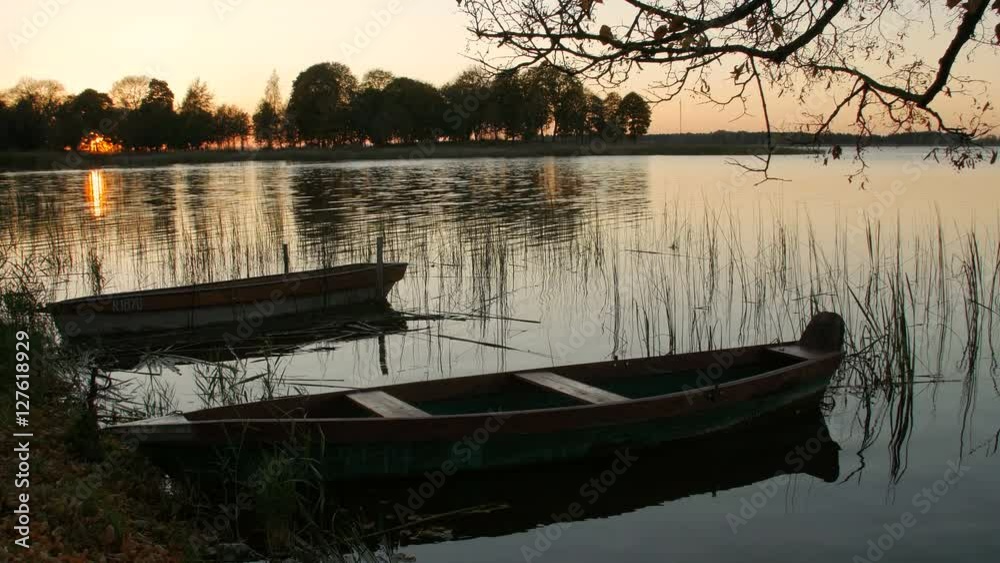 Two boats on the lake shore, evening, autumn Two boats on the lake shore, evening, autumn