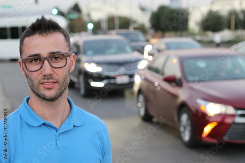 Business man in front of city traffic jam blurred