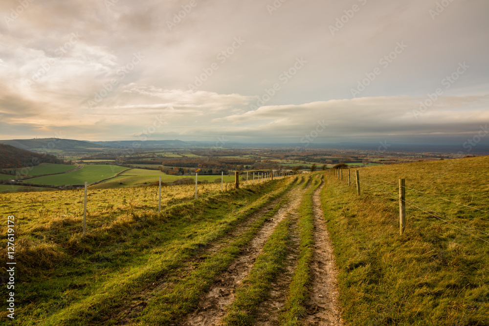 Footpath on Wolstonbury Hill, South Downs, Sussex, England taken on an autumn late afternoon,