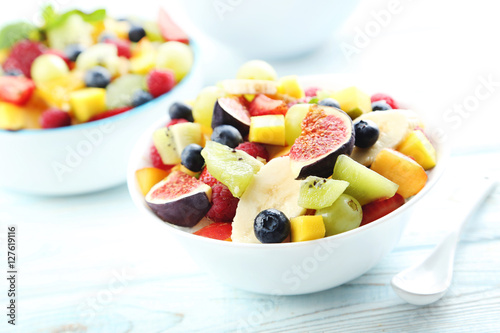 Fresh fruit salad on a white wooden table