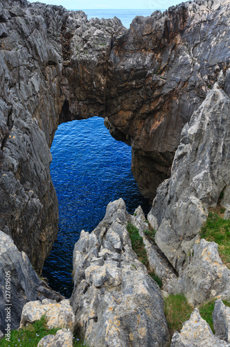 Rocky arch near shore, Spain.