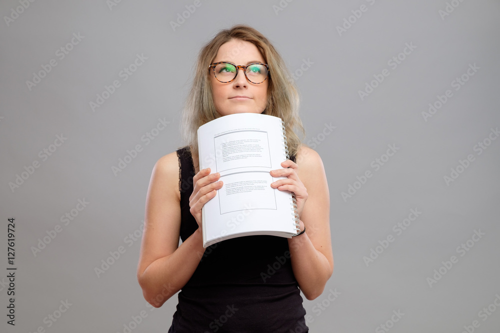 Student girl with glasses holding a book Student girl with glasses holding a book