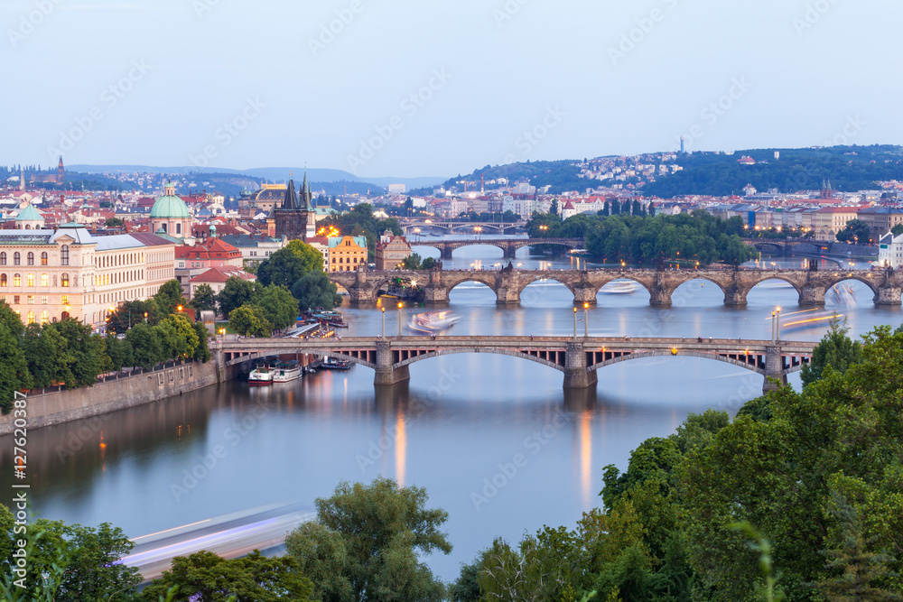 Panorama of the old part of Prague from the Letna park at dusk. Beautiful view on the bridges over the river Vltava at sunset. Old Town architecture, Czech Republic.