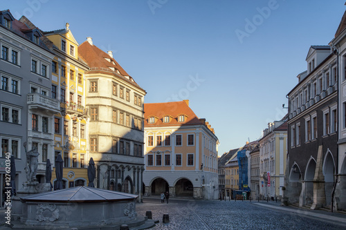 Historic buildings in bright colors at medieval Untermarkt (lower market) with Neptune fountain in Goerlitz, Germany.