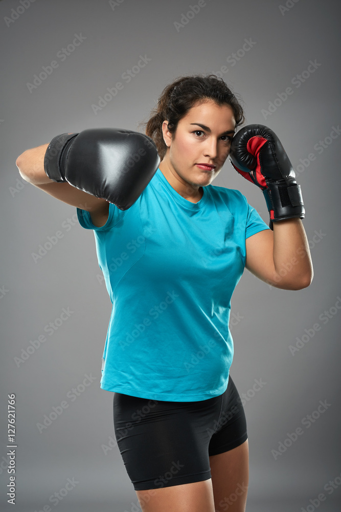 Latino female fighter throwing a hook Latino female fighter throwing a hook