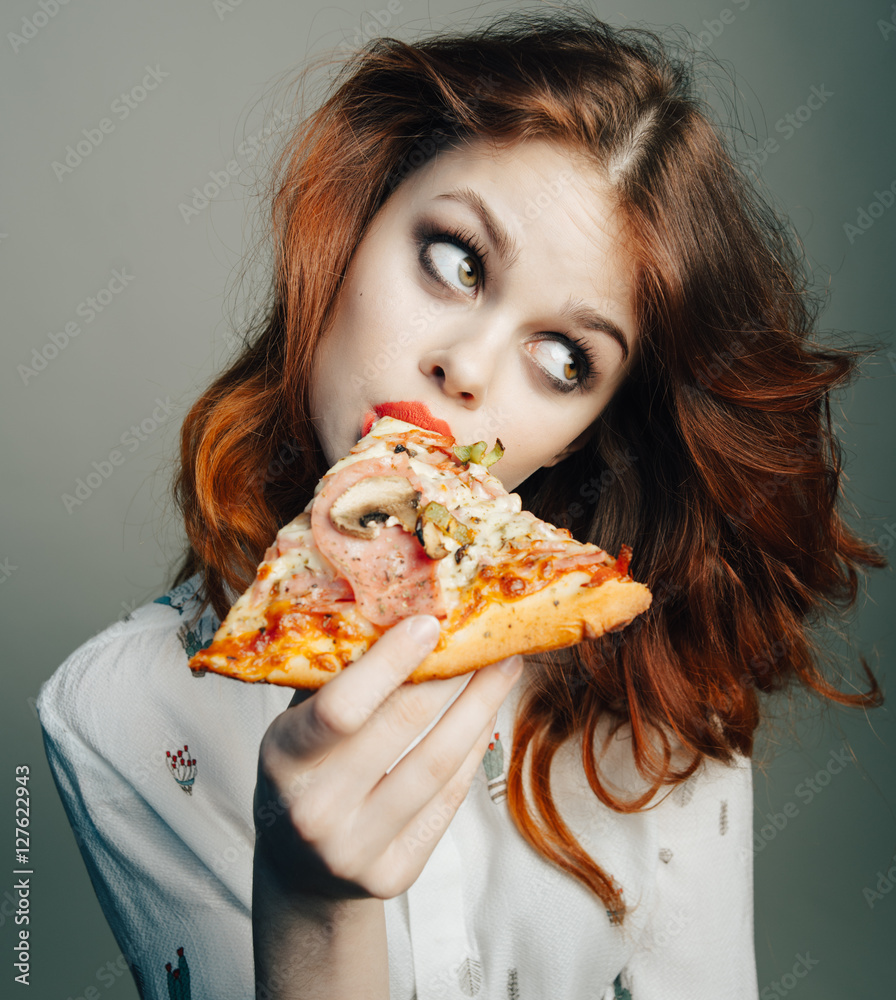 Woman with pizza. Pizza in the mouth. Woman eating pizza
