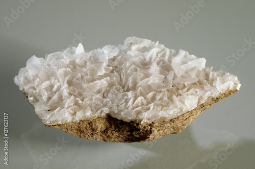 Calcite white crystal formation over a rock substrate photo