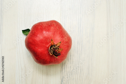 sweet pomegranates on white wood background