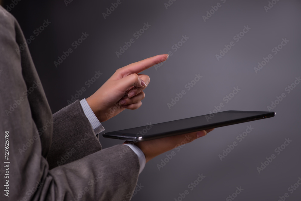 Businesswoman working on tablet computer in business concept
