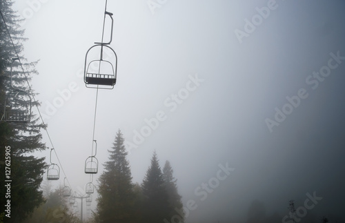 foggy, dark landscape with empty, abandoned chairlift to Gubalowka, Zakopane - Tatry, Poland
