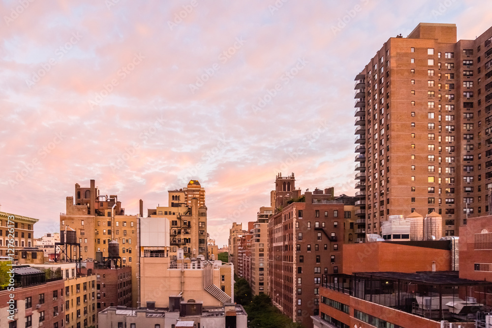 Fototapeta premium Balcony view of a New York City neighborhood with a colorful morning sky.