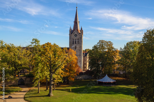 Autumn park with old medieval church in Cesis town, Latvia
