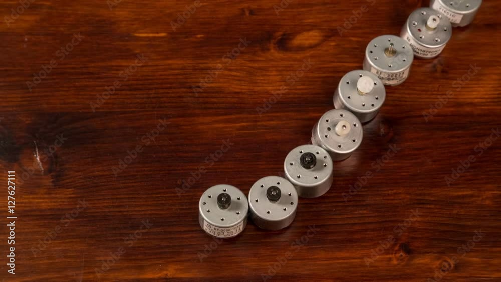 little electric DC motors moved on wooden table, stop motion ani little electric DC motors moved on wooden table, stop motion ani