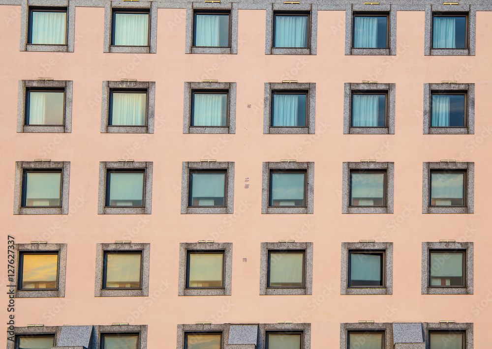 repeating pattern of windows Building front background / windows in hotel building / vintage building and window frame background / Building with colorful windows.