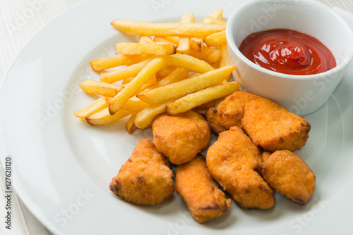 Chicken nuggets with french fries and ketchup