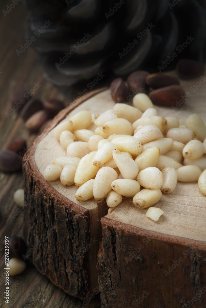 Peeled pine nuts on a wooden stand Peeled pine nuts on a wooden stand