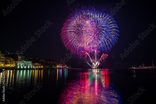 Colorful fireworks over the water on the beach